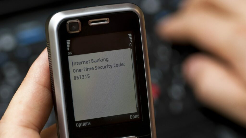 A feature phone displaying the message "Internet Banking One-Time Security Code: 867315"