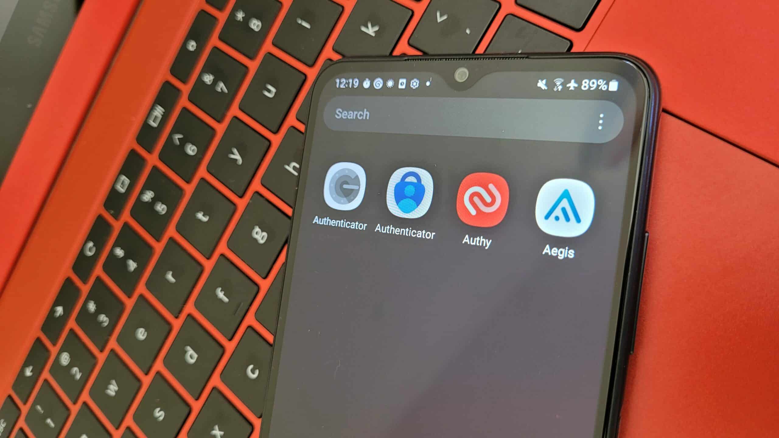 A smartphone screen displaying the icons for Google Authenticator, Microsoft Authenticator, Authy, and Aegis, all of which are authenticator apps.