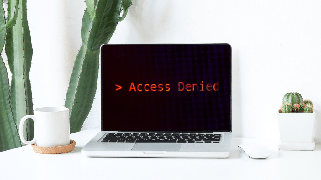 A laptop with the text "Access Denied."