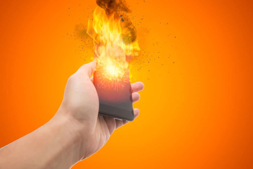 A phone explodes and is on fire.
