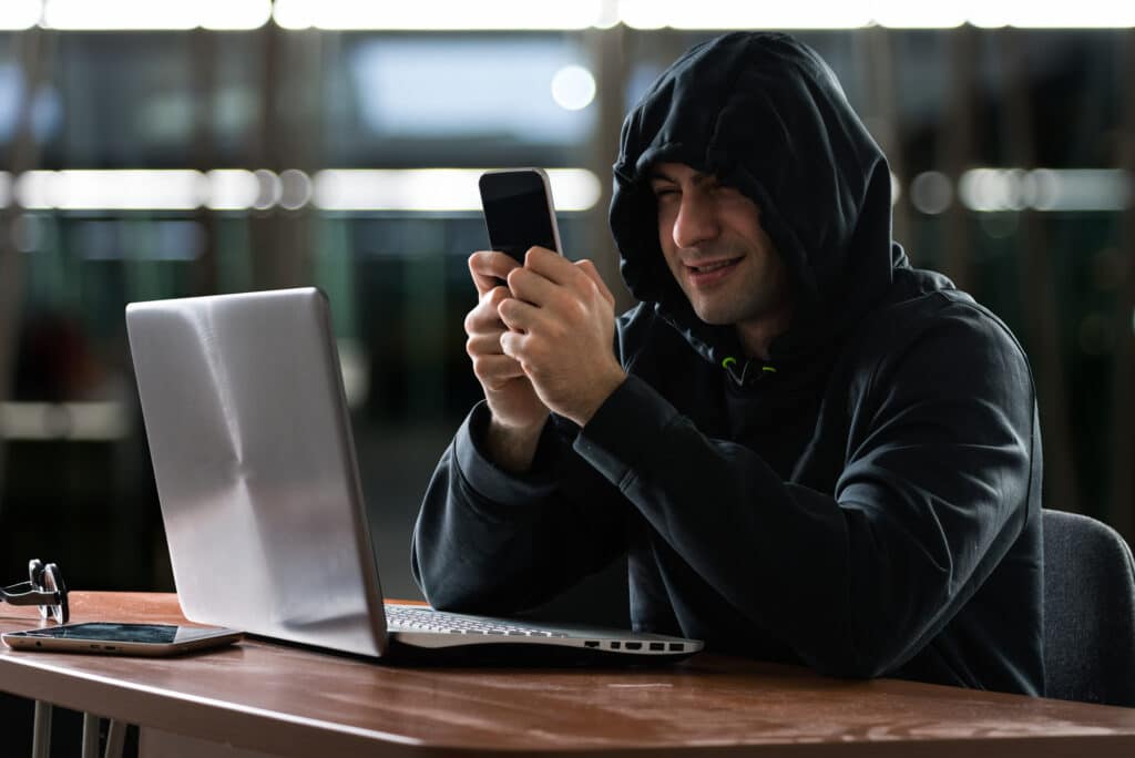 Hacker using a smartphone