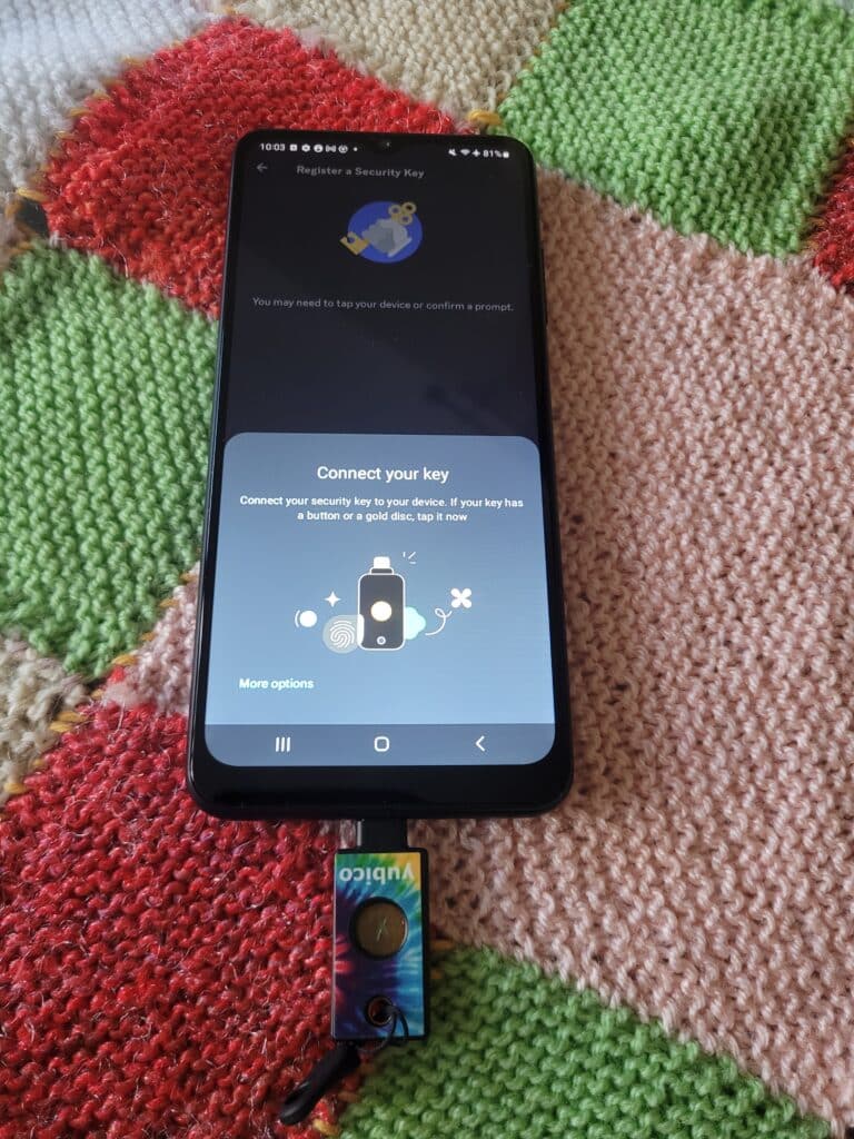 A security key connected to an Android phone during the set up process with Discord.